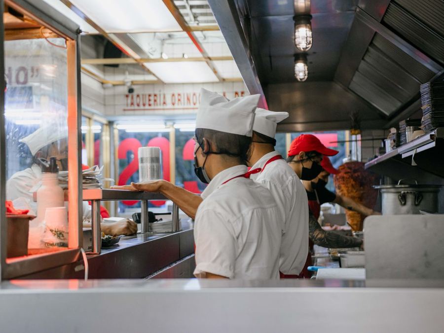 Fast food crew preparing orders in a restaurant kitchen